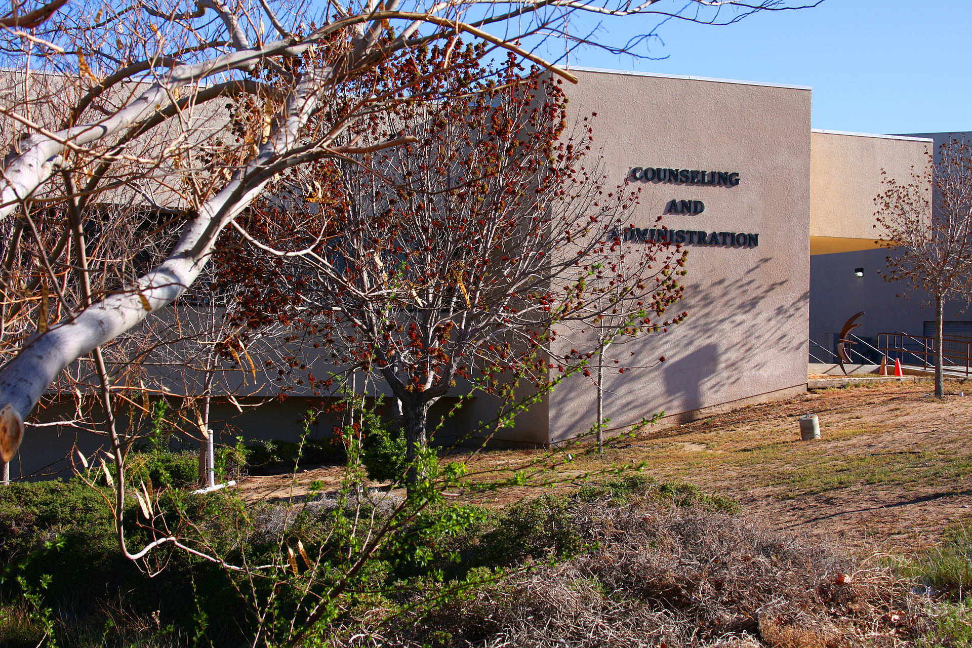 A VVC exterior bearing the sign Counseling and Administration, behind tree branches, photographed in 2009